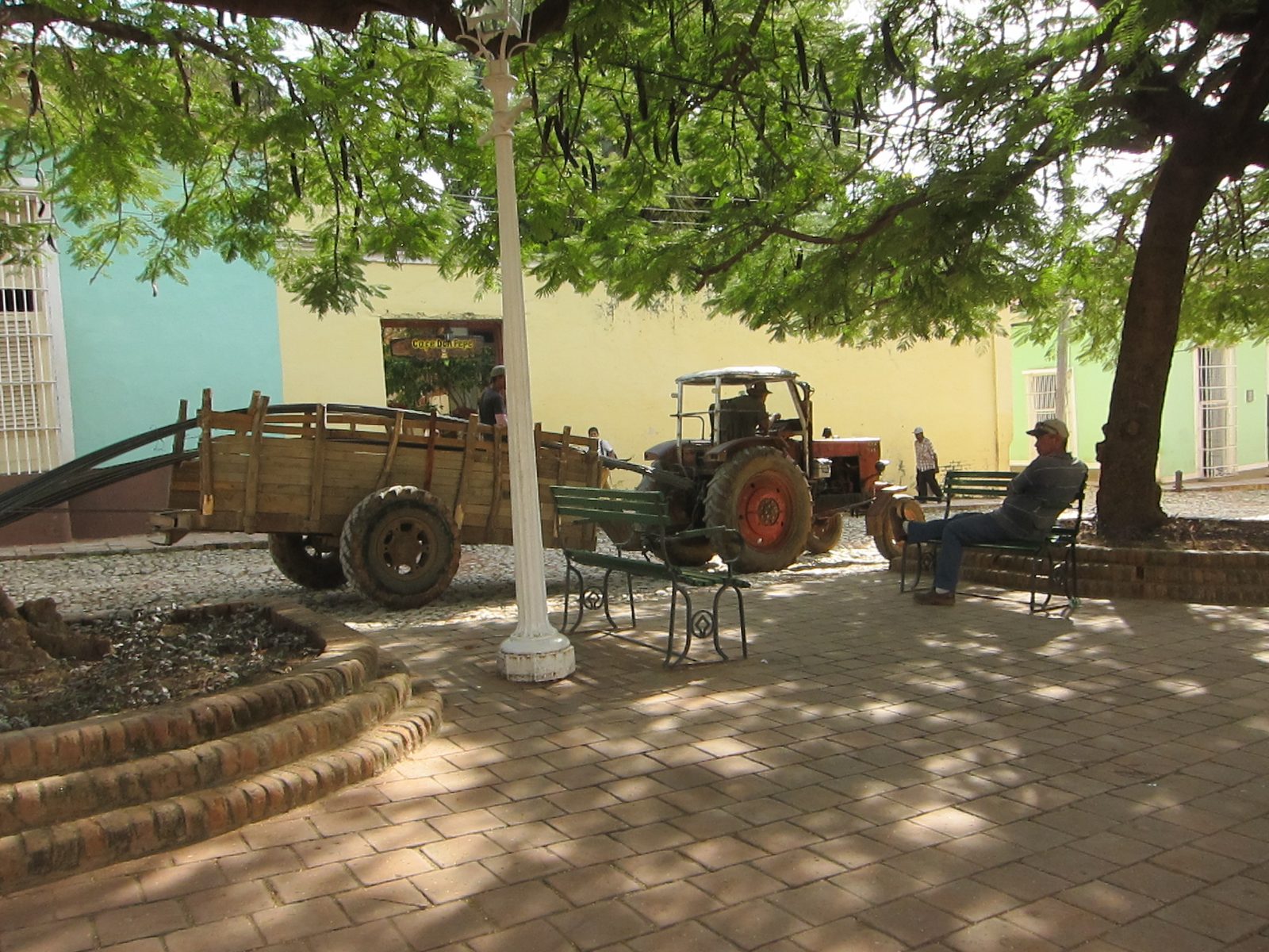 A tractor dragging rebar through the town
